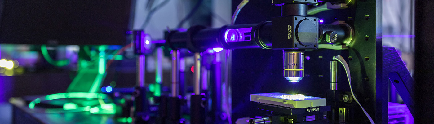 Lab equipment illuminated in blue and green light