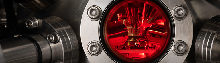 Close-up of equipment with red light on the inside of silver metal